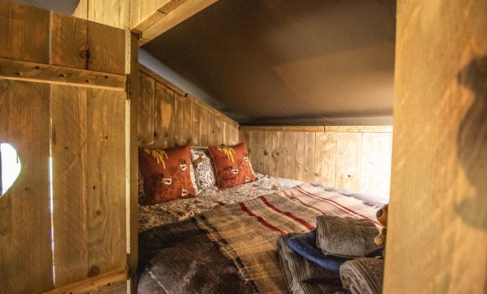 Cosy double bed cabin with blankets and hot water bottles.